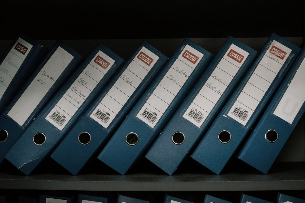 Rows of blue batch-record binders on a shelf